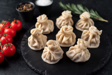 Khinkali, Georgian dumplings with meat filling on a stone background