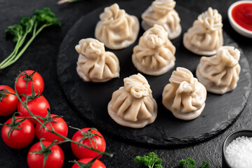 Khinkali, Georgian dumplings with meat filling on a stone background