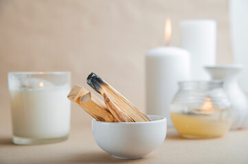 Palo Santo bars close-up and copy space. Ritual cleansing with sacred ibiocai, meditation, aromatherapy with incense and candles..