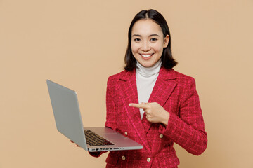 Smiling happy fun copywriter student woman of Asian ethnicity 20s wear red jacket hold use work...