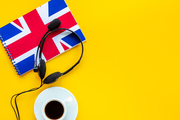 Notebook with British flag and headphones. English lessons concept