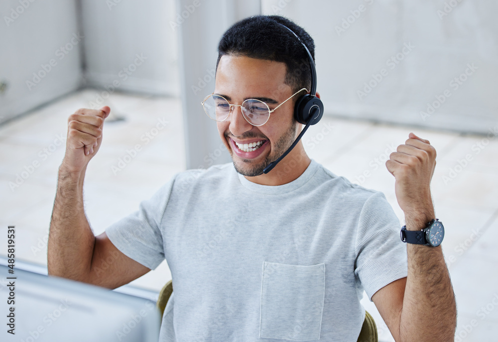 Poster so close to hitting my target i can taste it. shot of a young businessman working in a call center o