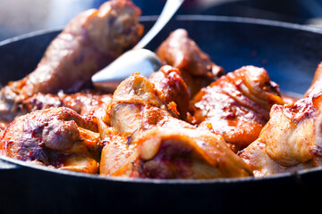 Cooked pork knuckles in a frying pan
