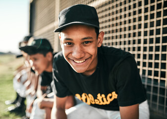 Obraz premium I play for the fun of it. Portrait of a young baseball player sitting on a baseball field.