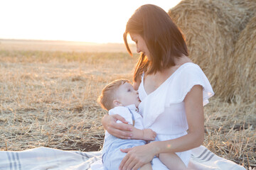 Mom is nursing her child in nature.