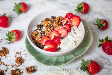 Sirtuin muesli in a white bowl on a marble background