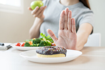 Diet, Dieting asian young woman or girl use hand push out, deny sweet donut and choose green salad...