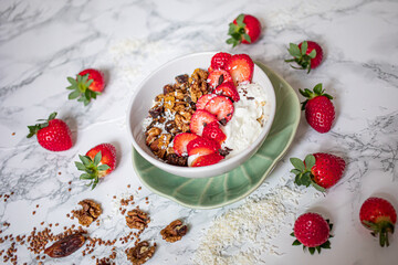 Sirtuin muesli in a white bowl on a marble background