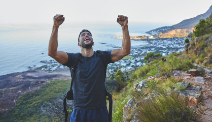 The next mountain I climb will be even harder. Shot of a young man celebrating the completion of...
