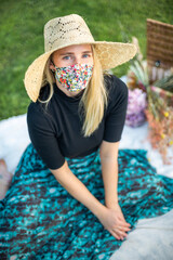 Portrait of a woman with blonde hair wearing a coronavirus face mask covering during Covid-19 pandemic lockdown