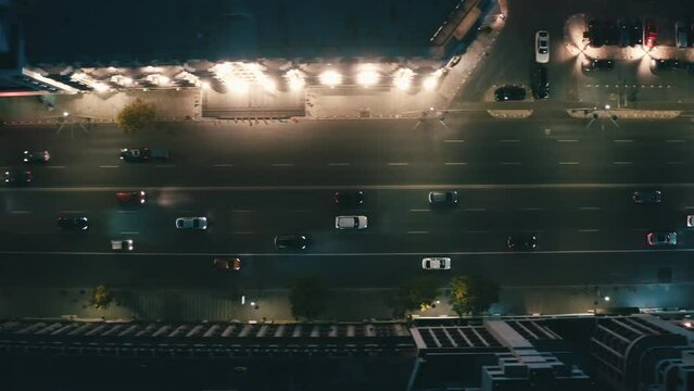 Aerial view of night streets in downtown Bucharest, Romania, with bright night illumination. cars drive through the streets of the night city. Wide shot with smooth cinematic drone motion. 4k footage