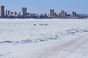 Amur river in winter. State border. Buildings in Heihe city, China. Temporary constructions of...