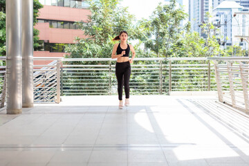 Thai Asian women in gym clothes are jogging.