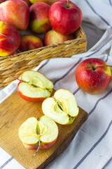 fresh red apples on wooden plate chopped