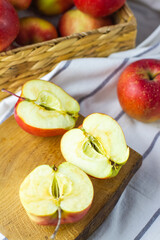 fresh red apples on wooden plate chopped closeup
