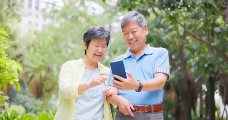elderly couple using mobile