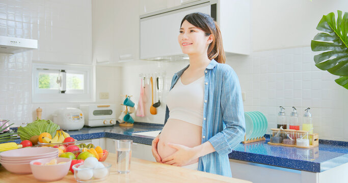 Asian pregnant woman take vitamin
