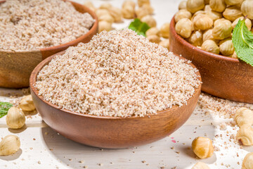 Alternative keto diet gluten grain free flour. Paleo and ketogenic diet baking cooking concept. Hazelnut flour with whole nuts