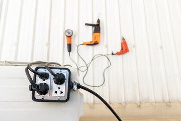 Close-up of silver colored trailer plug 4 sockets  on the roof for use with hand tools.