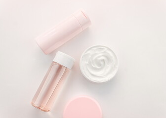 Flat lay composition with cosmetic products on a white background. Top view
