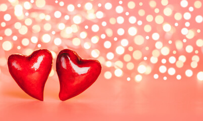 Valentine's day card. Two red hearts on the background of blurry lights, banner.