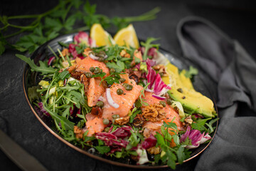 Super Sirtuin salad in a stylish black plate over black background