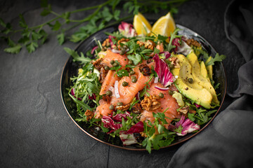 Super Sirtuin salad in a stylish black plate over black background