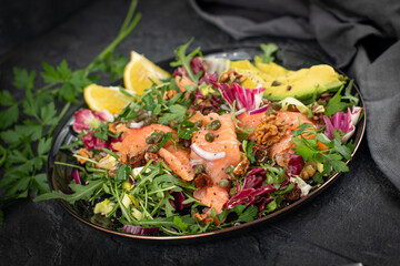 Super Sirtuin salad in a stylish black plate over black background