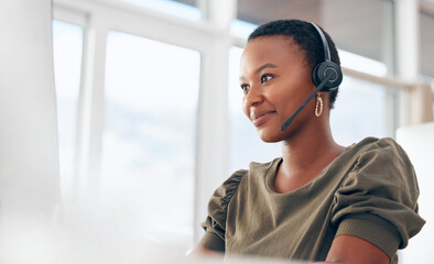 Fototapeta If you need us, call. Shot of a woman wearing a headset while working in a call centre. obraz