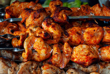 The meat is grilled. Pieces of kebab are fried on the fire. Meat on skewers close up.