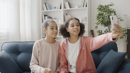 Teenage vloggers filming video by smartphone app, social media, modern technology