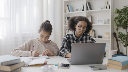 Exhausted teen girls studying at home, school time management, academic pressure