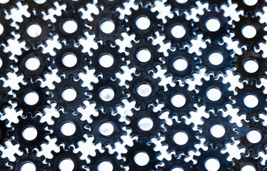 Fototapeta na wymiar Lots of gears on a white background. Iron gears are neatly stacked to each other on white.