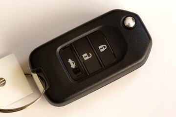 Car key with auto lock, unlock and trunk buttons on isolated white background.