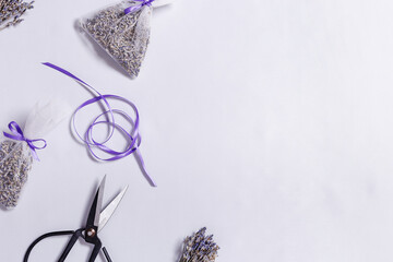 Making DIY lavender sachets for home, for gifts, natural scented bags from organza on white...