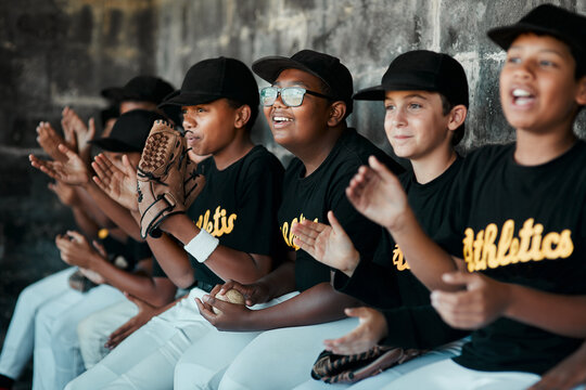 Their spirit is what keeps their team going. Cropped shot of a group of young baseball players cheering and supporting their team from the bench during a game.