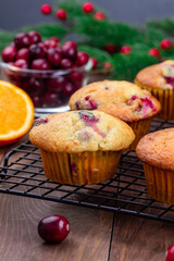 Cranberry orange muffins on cooling rack, vertical