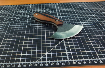 Special halberd cutting knife leather piece in workshop. Craft tanner tool production.