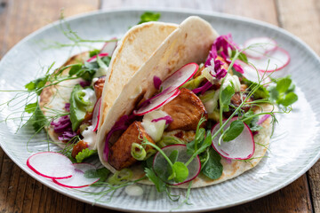 Tacos with salmon, pickled red cabbage, wasabi mayo and pea shoots