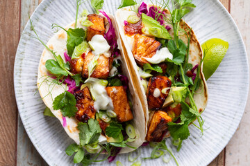 Tacos with salmon, pickled red cabbage, wasabi mayo and pea shoots