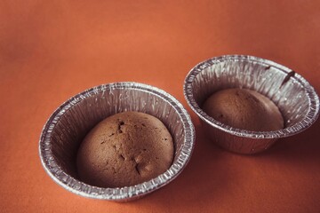 Two small homemade chokolate cupcakes in foil form