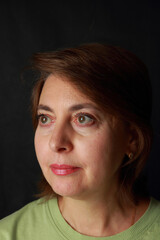 Fototapeta premium A middle-aged woman with a pensive look 