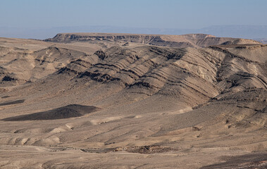 Fototapeta na wymiar View of Ramon Crater from West to East as seen from Mount Ramon, a 500m deep, the world's largest erosion cirque, located in the Negev Desert, south of Beer Sheba, near Mitzpe Ramon, Southern, Israel.