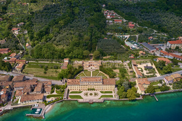 Fototapeta na wymiar Villa bettoni Lake Garda in Italy aerial view. Attractions on Lake Garda. Historic waterfront villa on Lake Garda. Italian villa bettoni, aerial view.