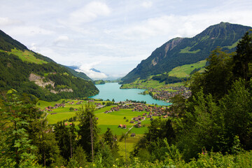 Lake, mountains and village. Aerial view on village in Austria