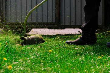 Garden work concept background. Mowing the grass with a lawn mower. Garden work concept background.