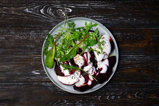 Selective Focus. Macro. Vegan Food. Beetroot Arugula Salad On A Plate With Yogurt Sauce And Olive Oil. Healthy Food. Diet Salad.