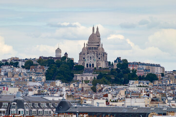 Fototapeta na wymiar Paris cityscape from above. Montmartre hill and Sacre Coer church stand out in the view