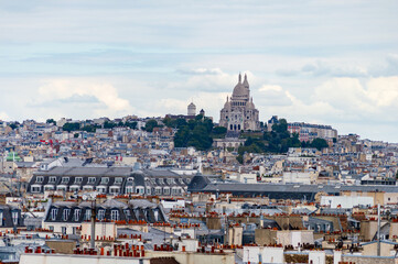 Fototapeta na wymiar Paris cityscape from above. Montmartre hill and Sacre Coer church stand out in the view