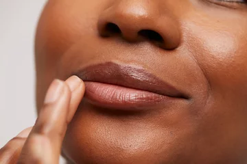 Fotobehang Close-up of woman touching lips © Cultura Creative